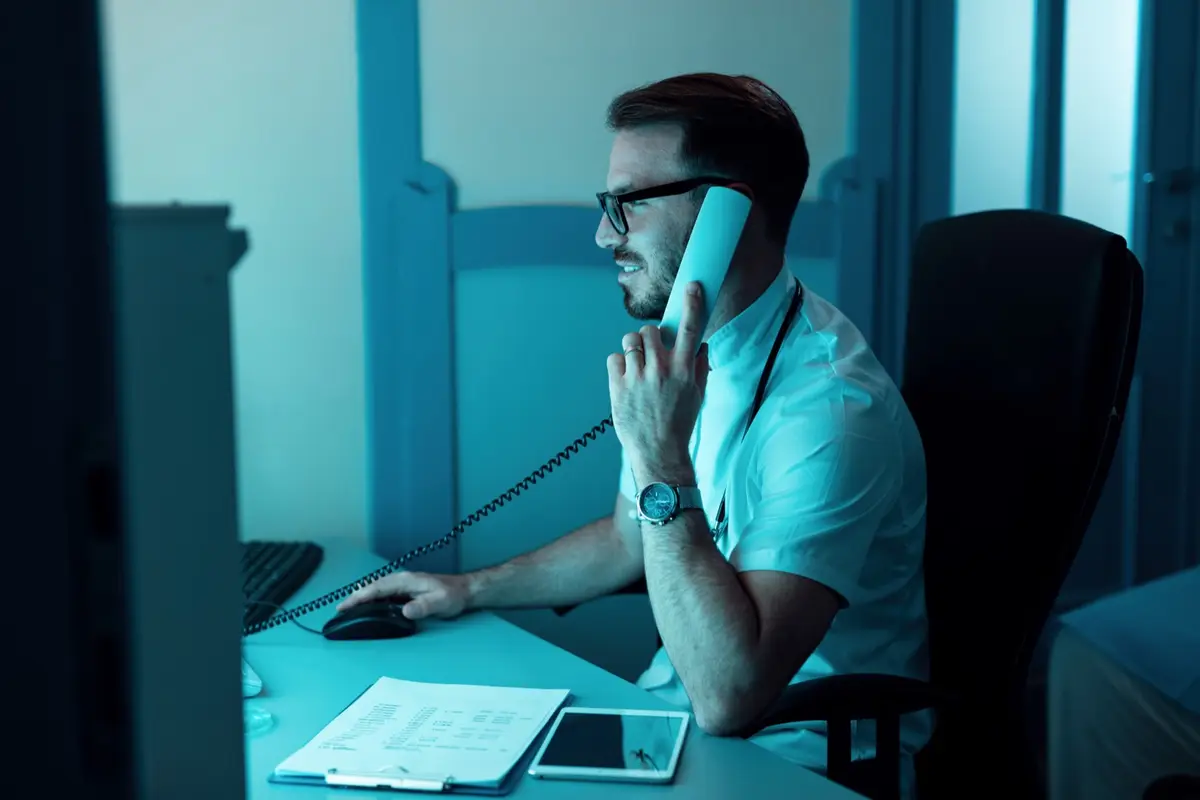 Customer support agent on a call at his desk