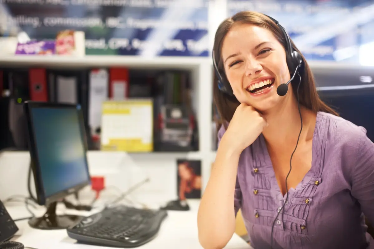 Smiling customer care agent wearing a headset