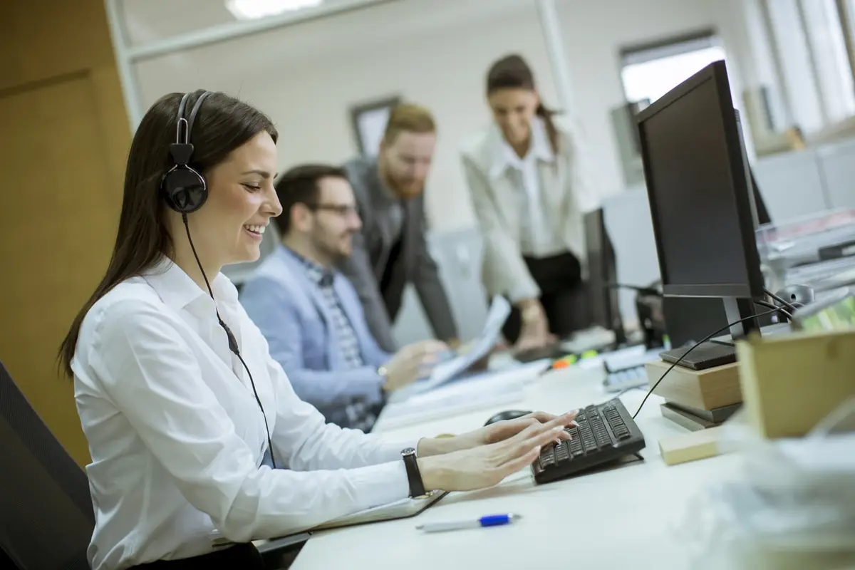 Agent with a headset working alongside colleagues