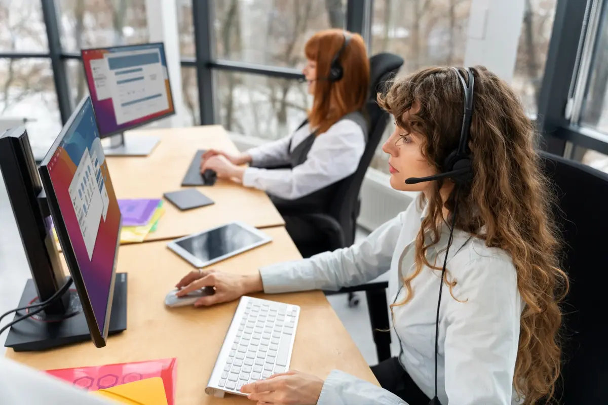 Call center agents with headsets at their workstations